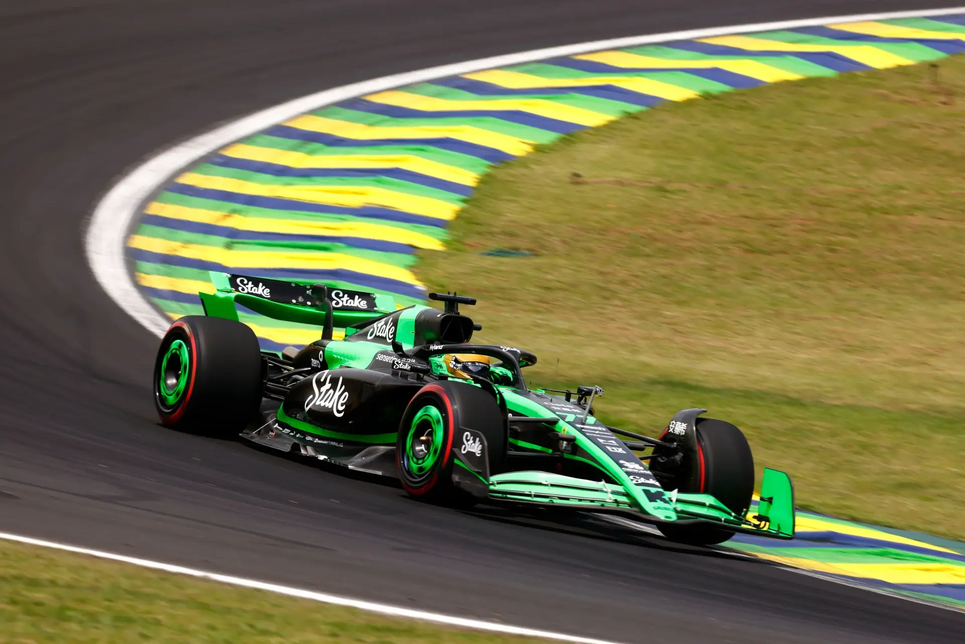 A Sauber Formula 1 car navigating a high-speed corner at the Interlagos circuit during the 2024 Brazilian Grand Prix Saturday session, preparing for race day.
