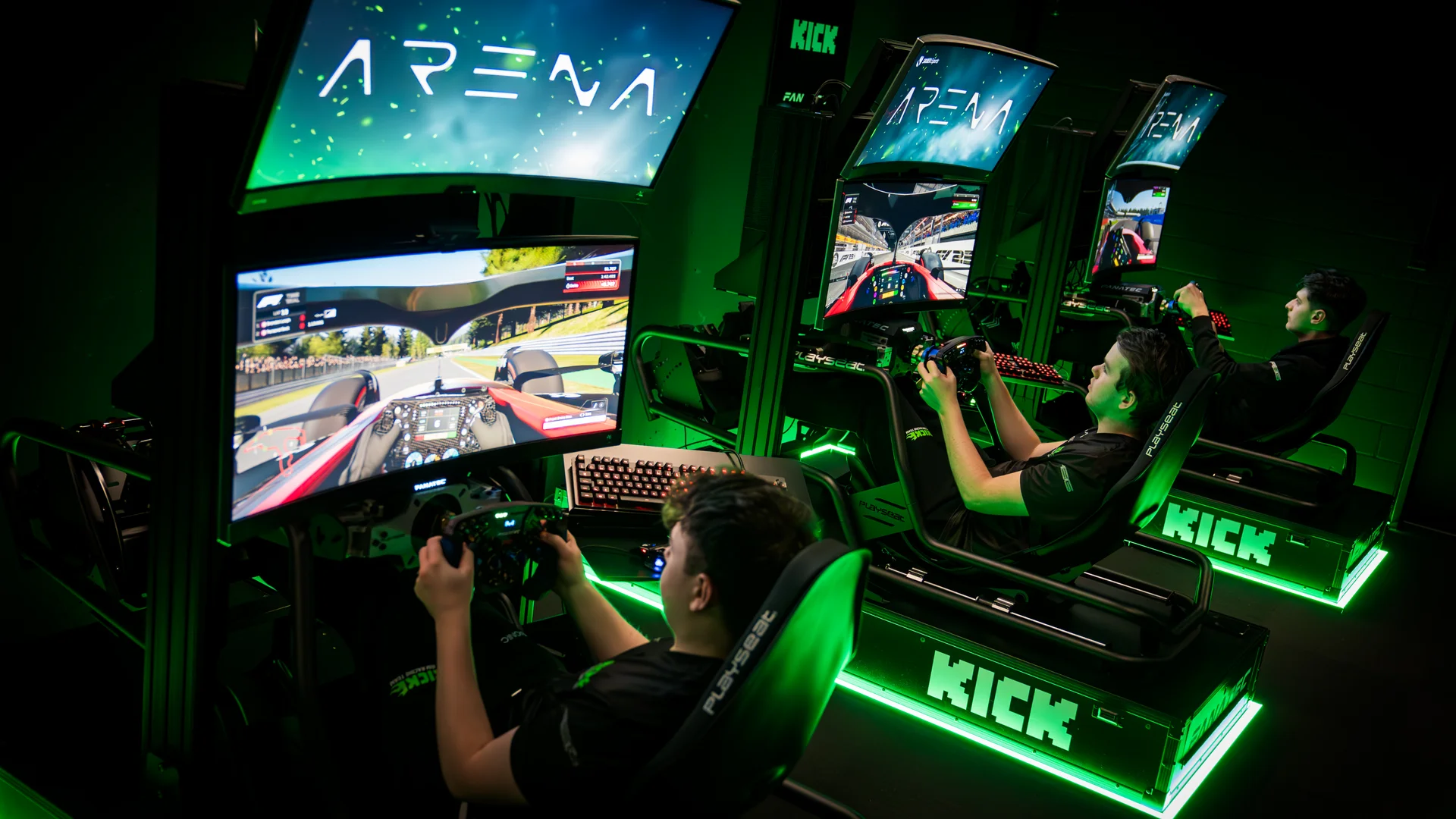 Esports players competing in a high-tech gaming arena with illuminated setups and multiple screens.