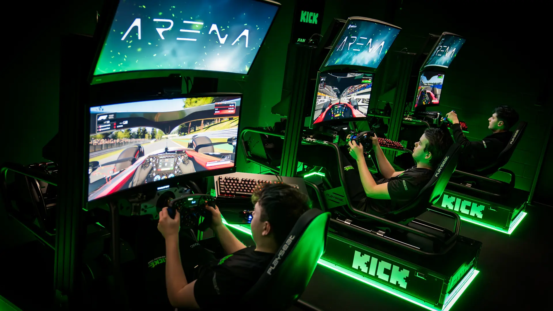 Esports players competing in a high-tech gaming arena with illuminated setups and multiple screens.