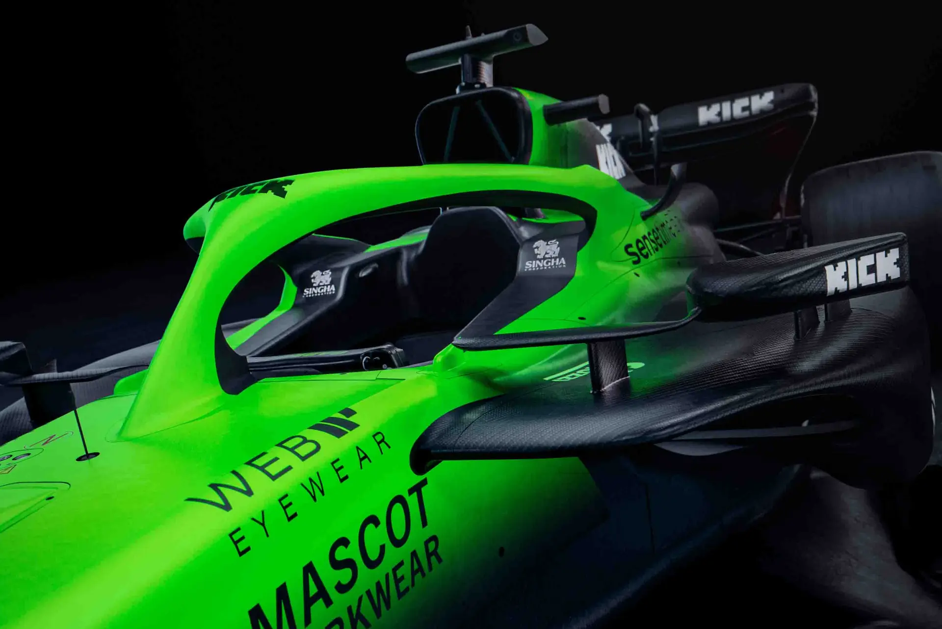 Close-up of the front-left section of the Sauber C45 Formula 1 car, showcasing aerodynamic details, cockpit area, and sponsor logos under dramatic lighting.