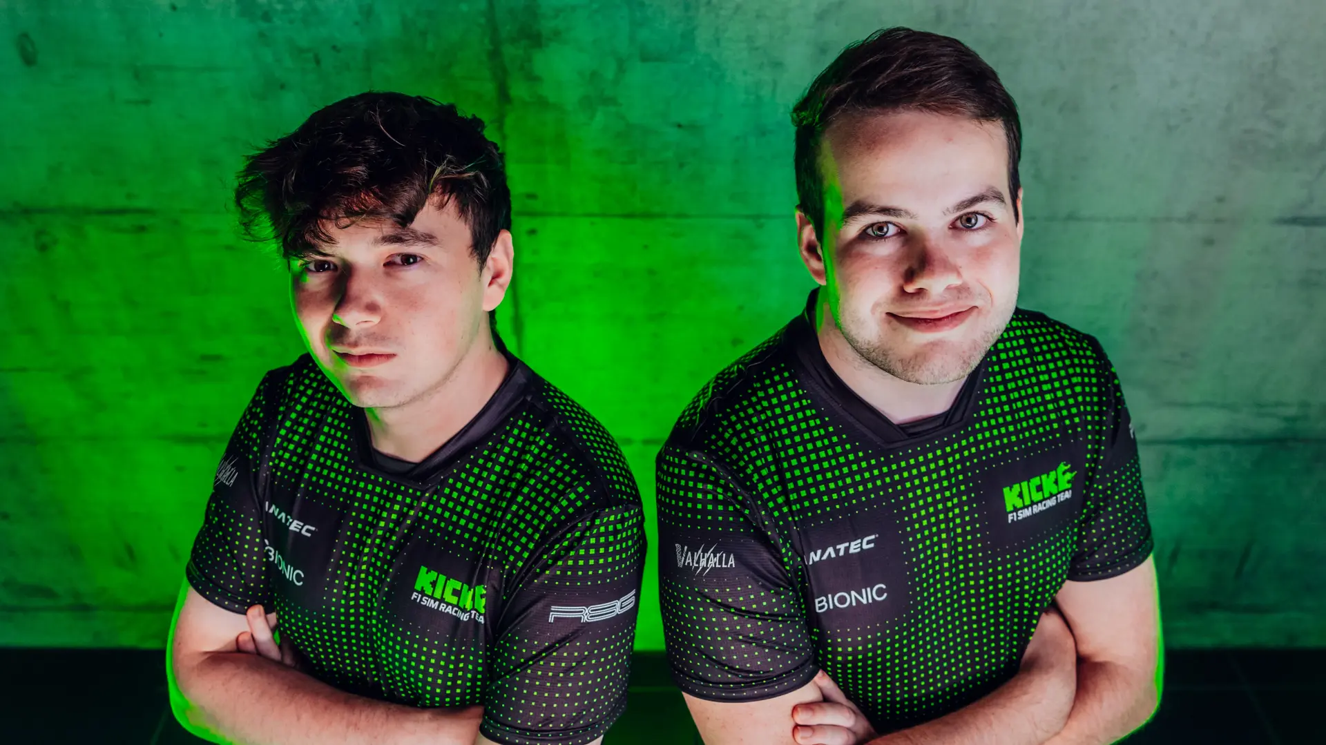 Thomas Ronhaar and Brendon Leigh, Sauber Motorsport Esports drivers, posing together with a green-lit background, representing their 2025 team spirit.