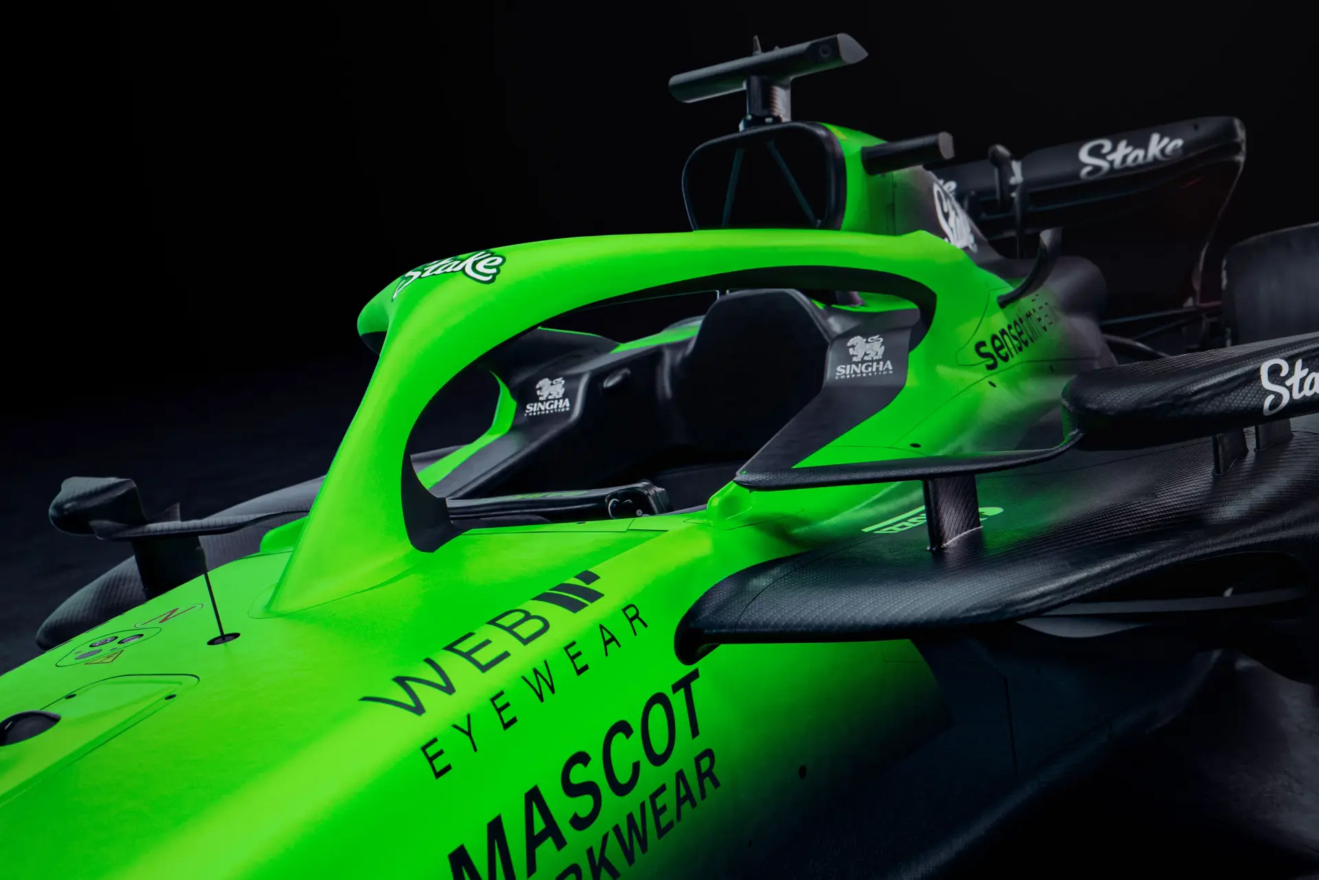 Close-up of the front-left section of the Sauber C45 Formula 1 car, showcasing the Stake branding, cockpit details, and vibrant green livery.