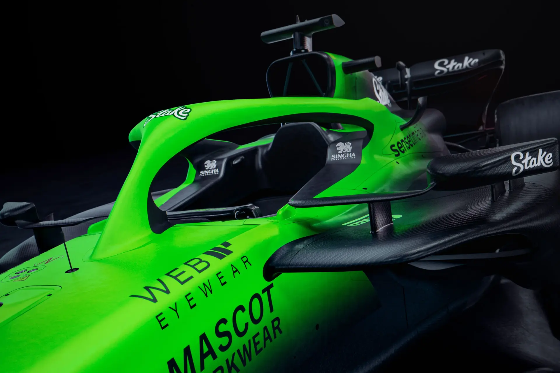 Close-up of the front-left section of the Sauber C45 Formula 1 car, showcasing the Stake branding, cockpit details, and vibrant green livery.