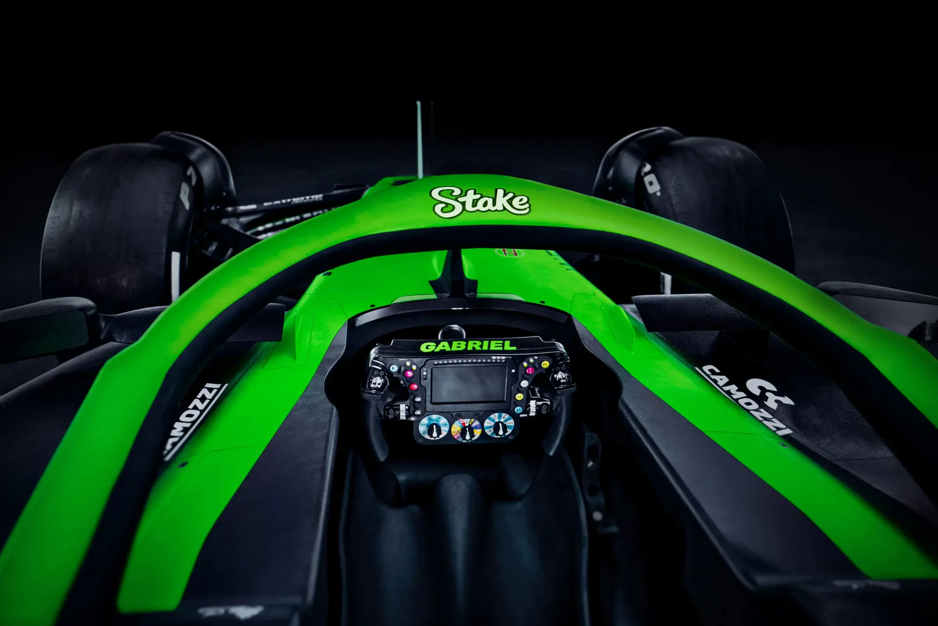 Close-up of the Halo device on the Sauber C45 Formula 1 car, featuring a bright green frame with Stake branding and cockpit details.