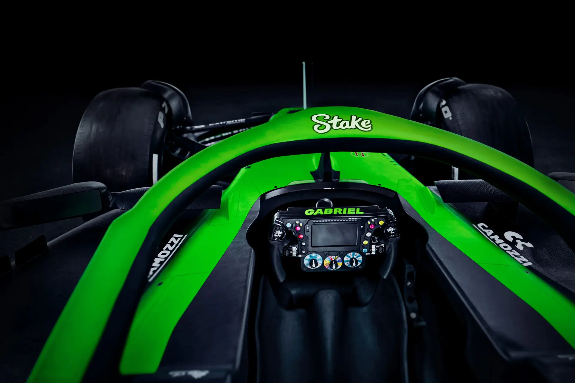 Close-up of the Halo device on the Sauber C45 Formula 1 car, featuring a bright green frame with Stake branding and cockpit details.