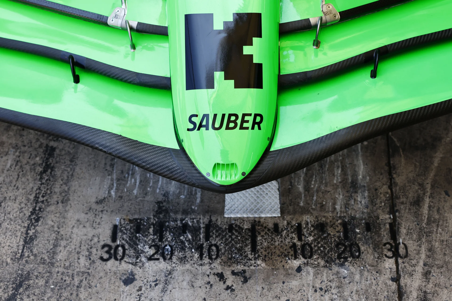 Close-up of the front wing of a Sauber Formula 1 car, featuring the Kick and Sauber branding, captured during the 2024 Brazilian Grand Prix on Friday.