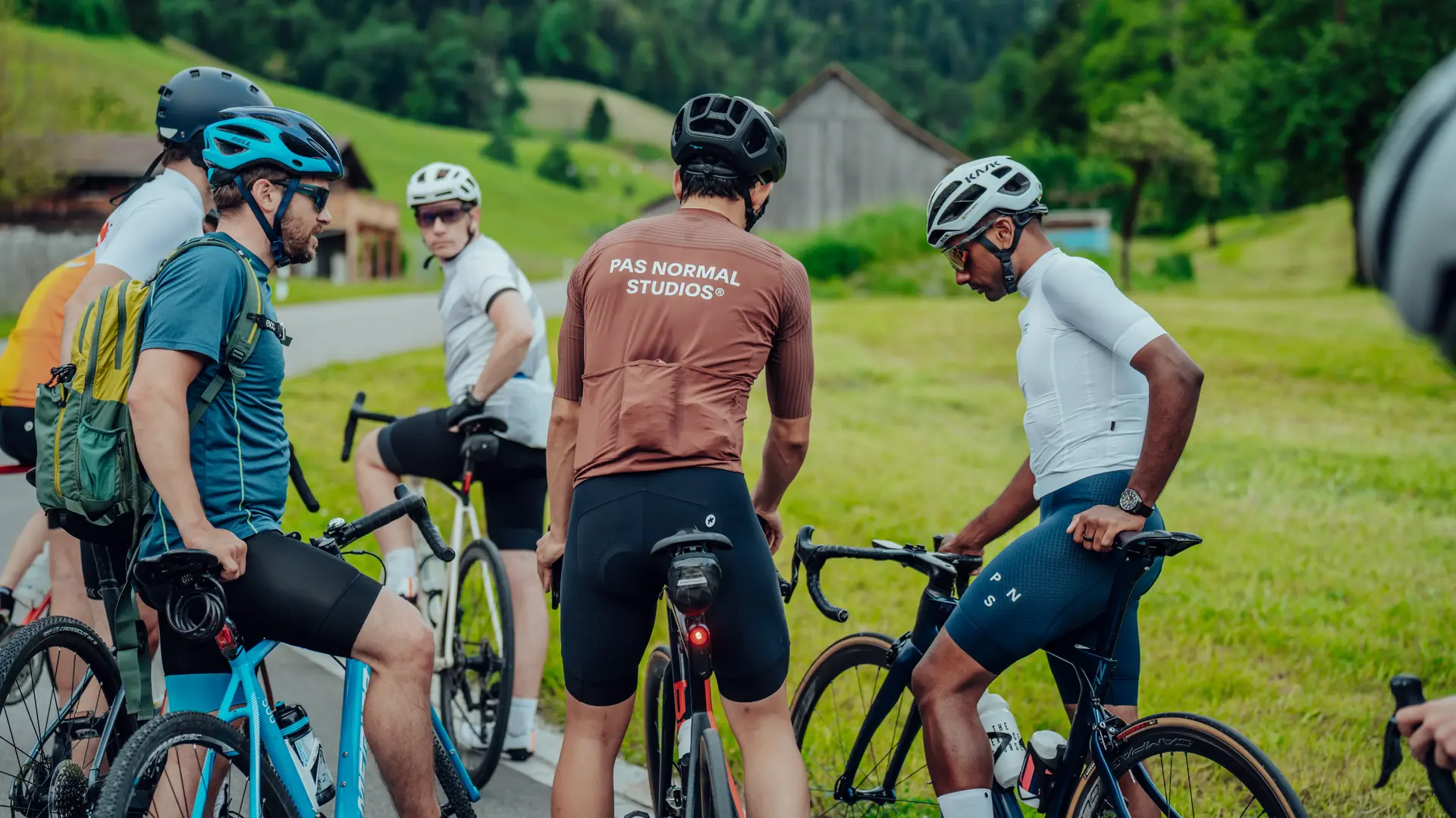 Group of Sauber Motorsport employees and cycling enthusiasts gathered for an industrial building for an afterwork cycling event.