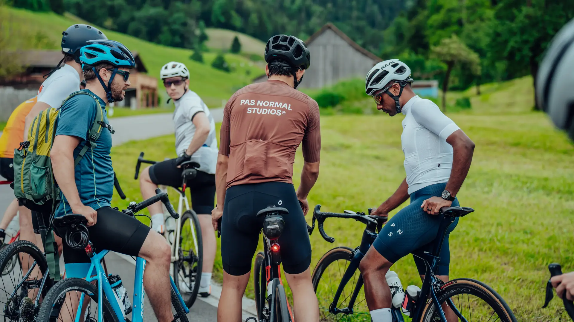 Group of Sauber Motorsport employees and cycling enthusiasts gathered for an industrial building for an afterwork cycling event.