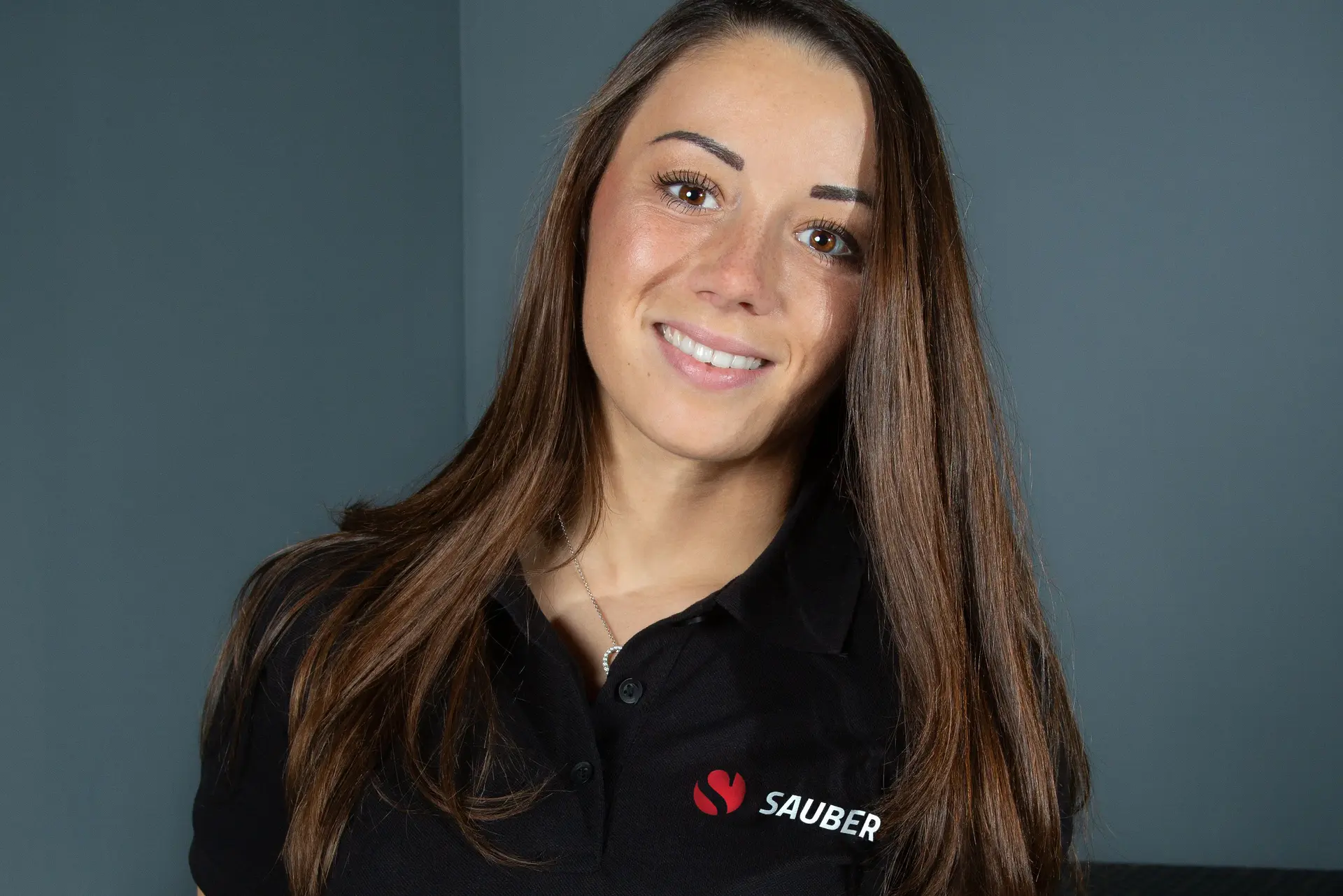 Carrie Schreiner wearing a Sauber Academy polo shirt, representing her involvement with the Sauber Academy program.