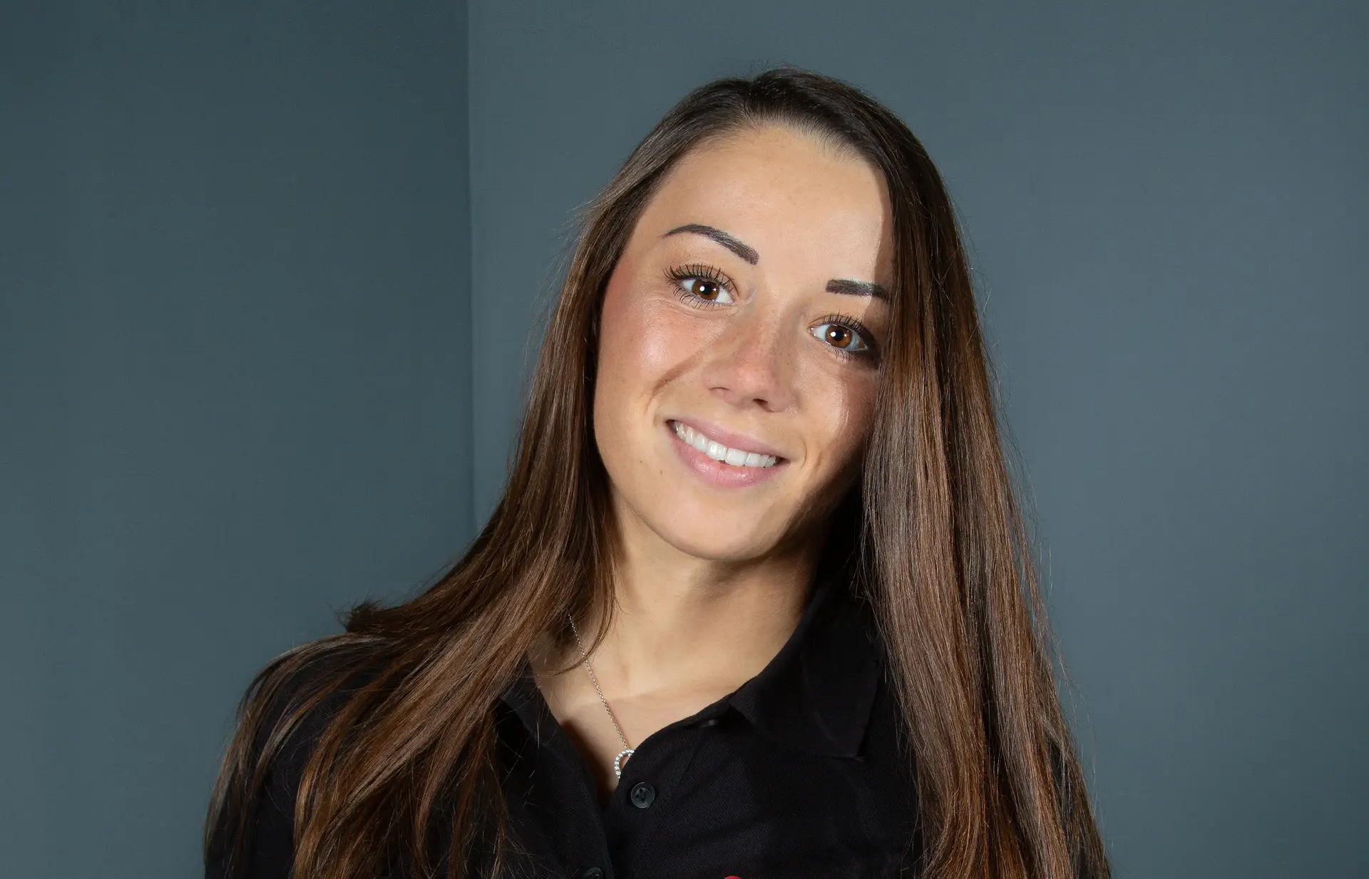 Carrie Schreiner wearing a Sauber Academy polo shirt, representing her involvement with the Sauber Academy program.