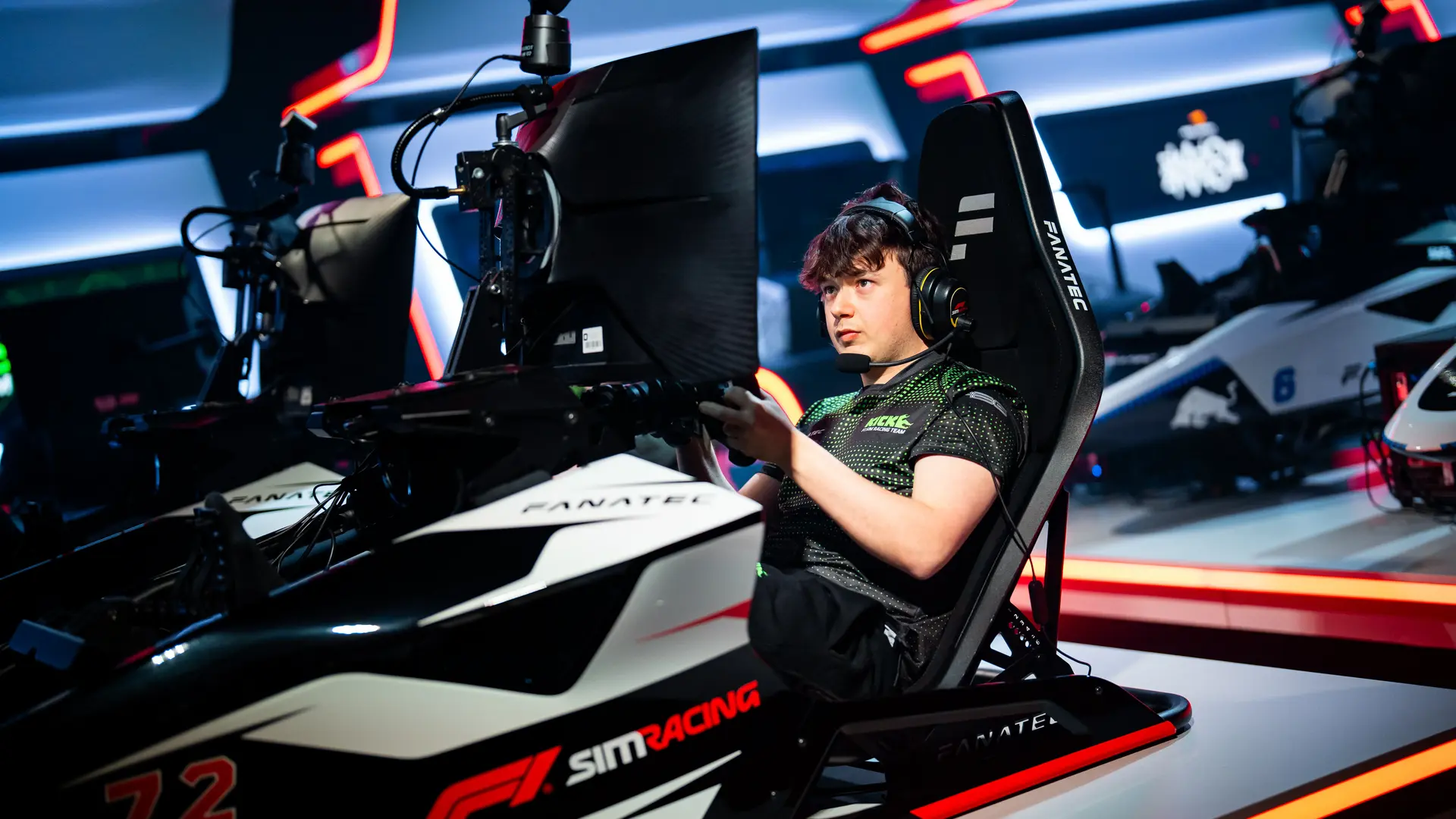 Brendon Leigh, Sauber Motorsport Esports driver, fully immersed in an F1 sim racing competition, gripping the wheel in a high-tech esports setup.