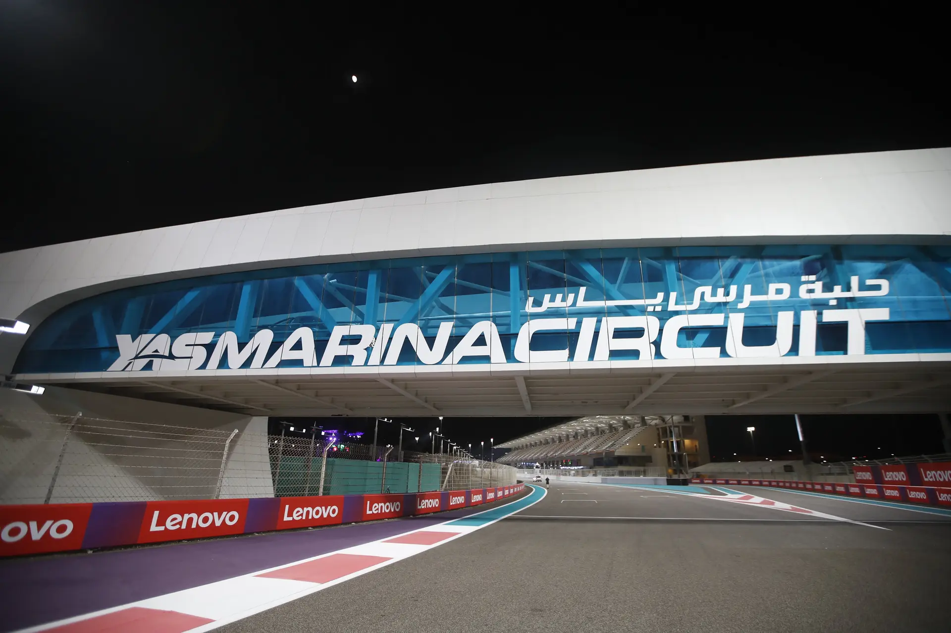A stunning night view of Yas Marina Circuit in Abu Dhabi, illuminated with bright lights and fireworks, setting the stage for the excitement of the 2023 Formula 1 Abu Dhabi Grand Prix.