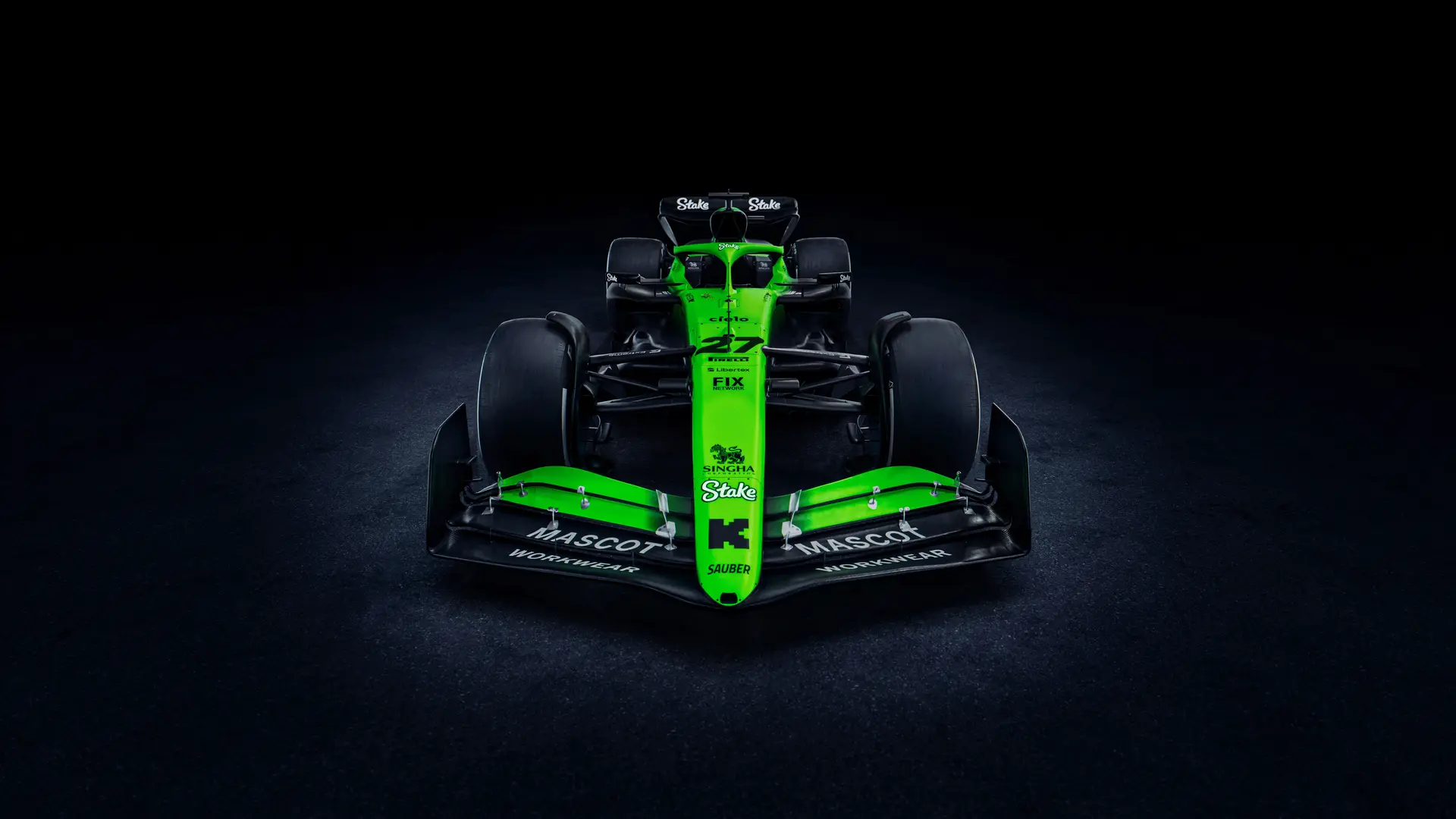 Front view of the Sauber C45 Formula 1 car, showcasing its aerodynamic front wing, Stake branding, and bright green and black livery under dramatic lighting.