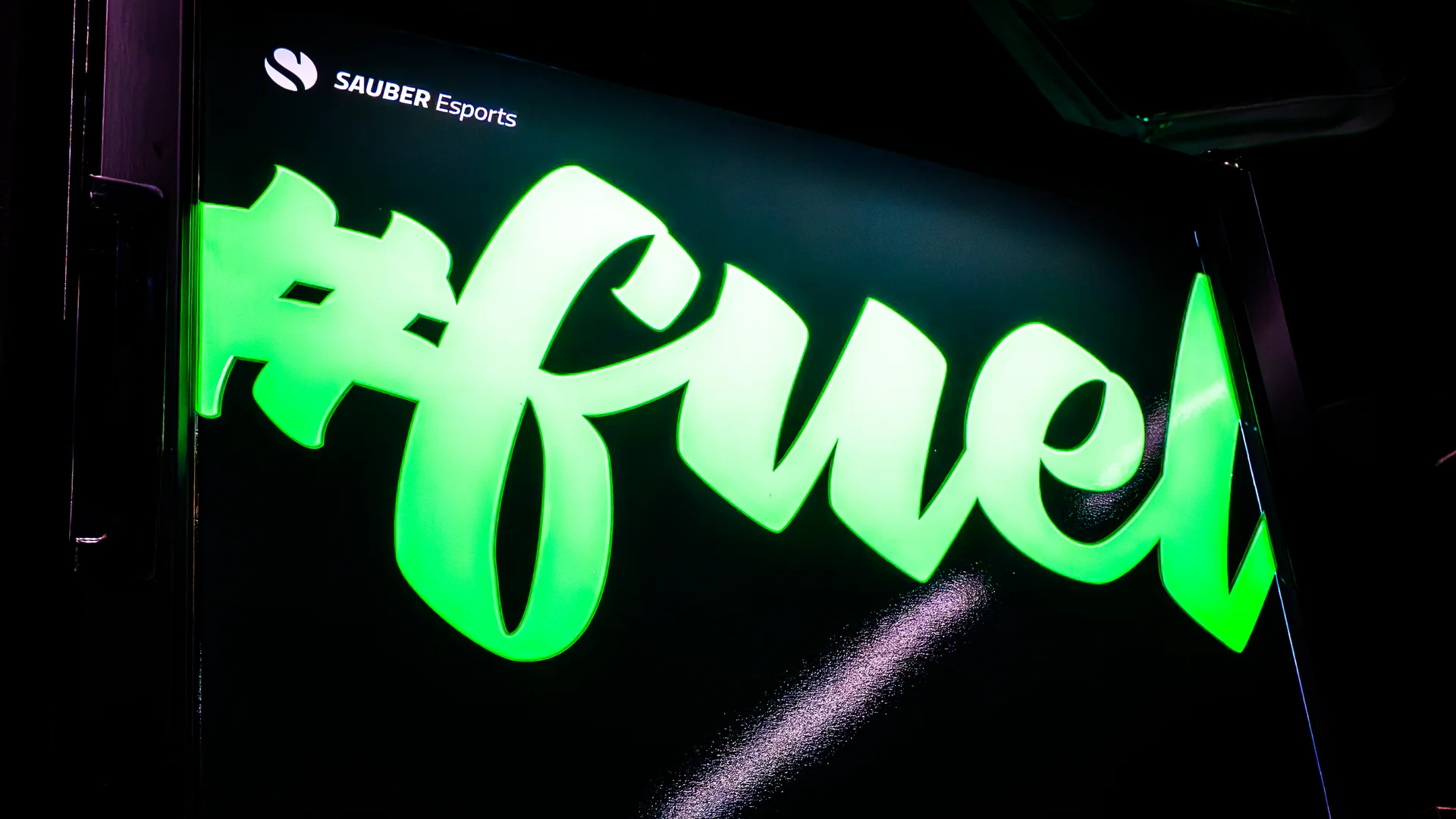 Illuminated esports arena signage featuring "Arena" and "Fuel" branding in a dark setting with neon lighting.