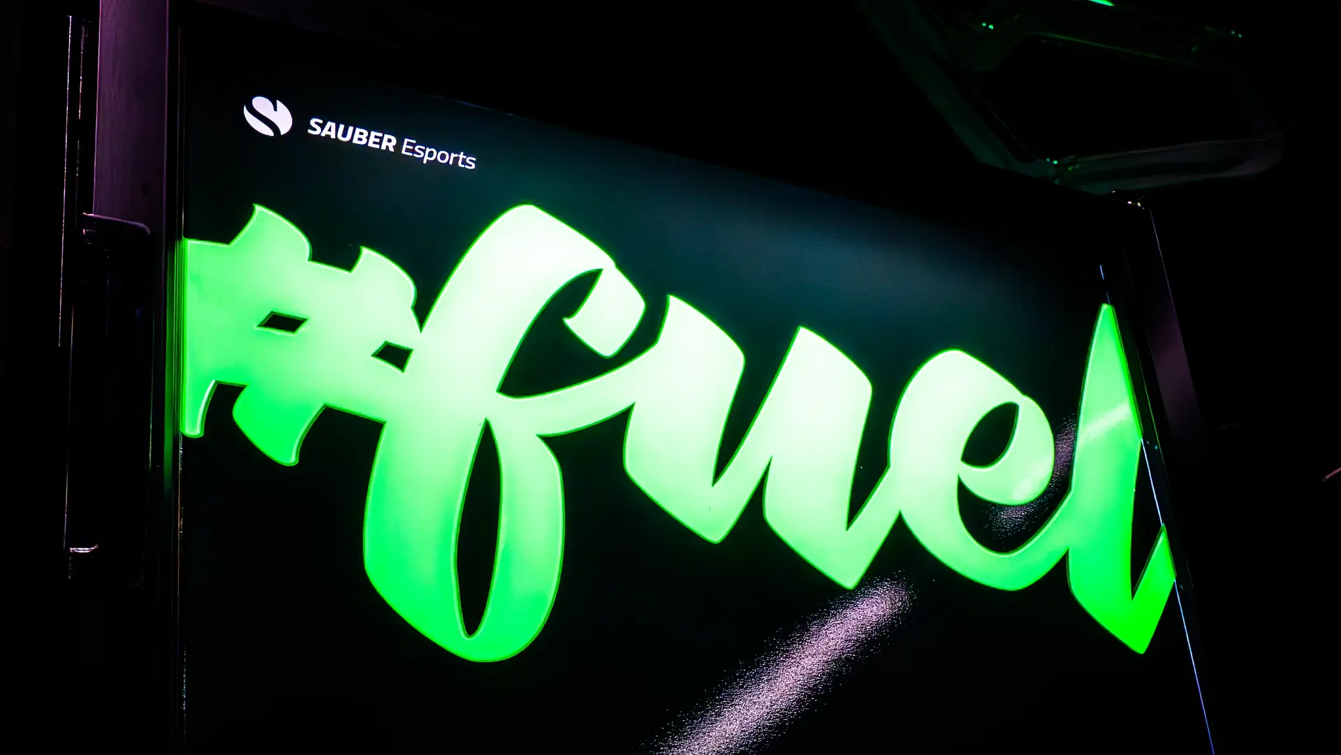 Illuminated esports arena signage featuring "Arena" and "Fuel" branding in a dark setting with neon lighting.