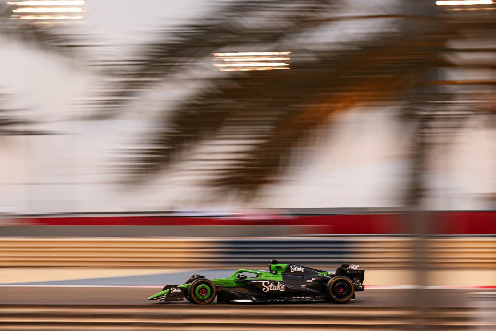 A Sauber F1 car speeding through the track during the 2025 pre-season testing, with motion blur capturing the intense pace and performance.