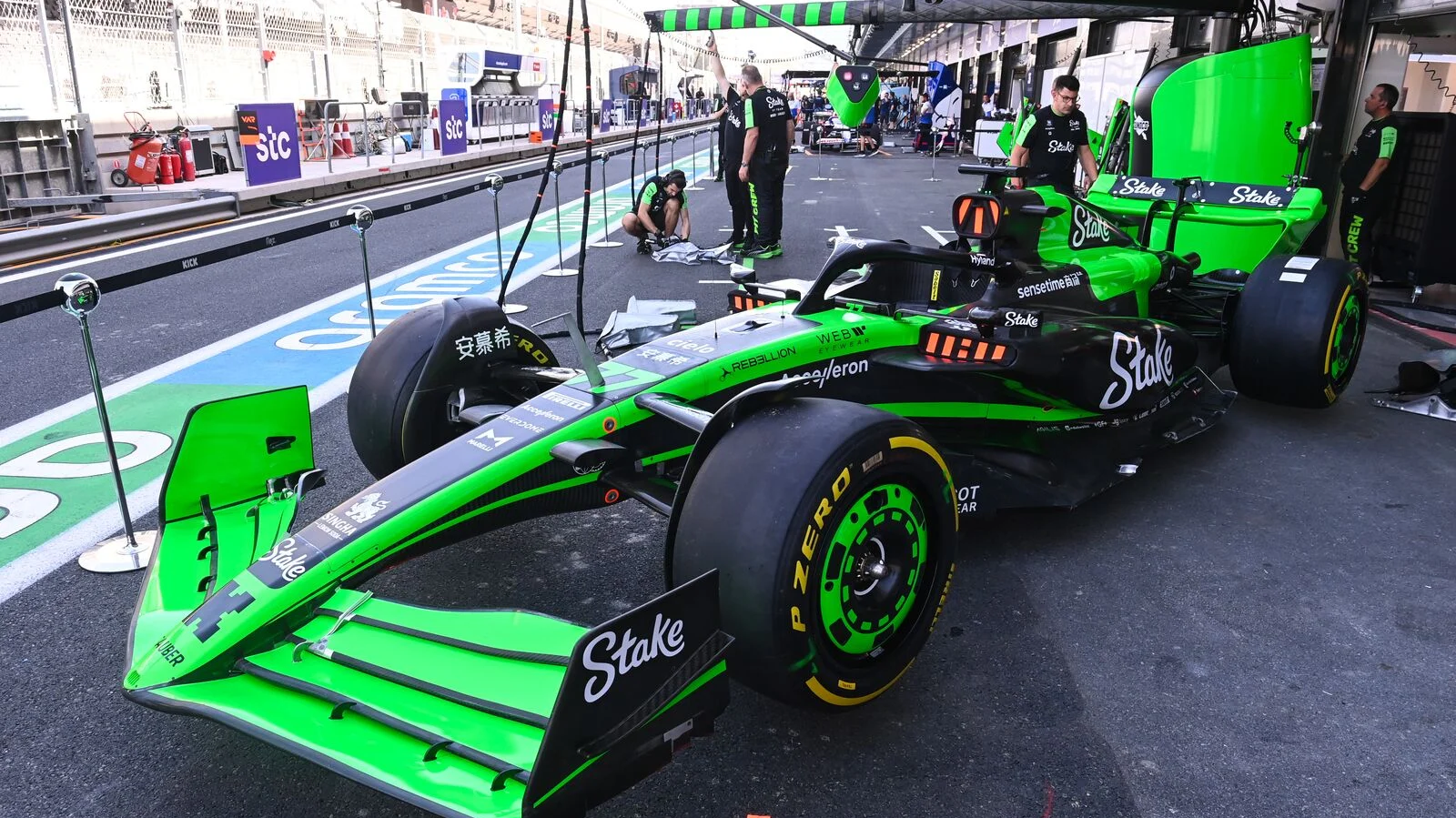 A green Formula 1 car parked in the pit lane during the Saudi Arabian Grand Prix, Thursday pre-race preparations.