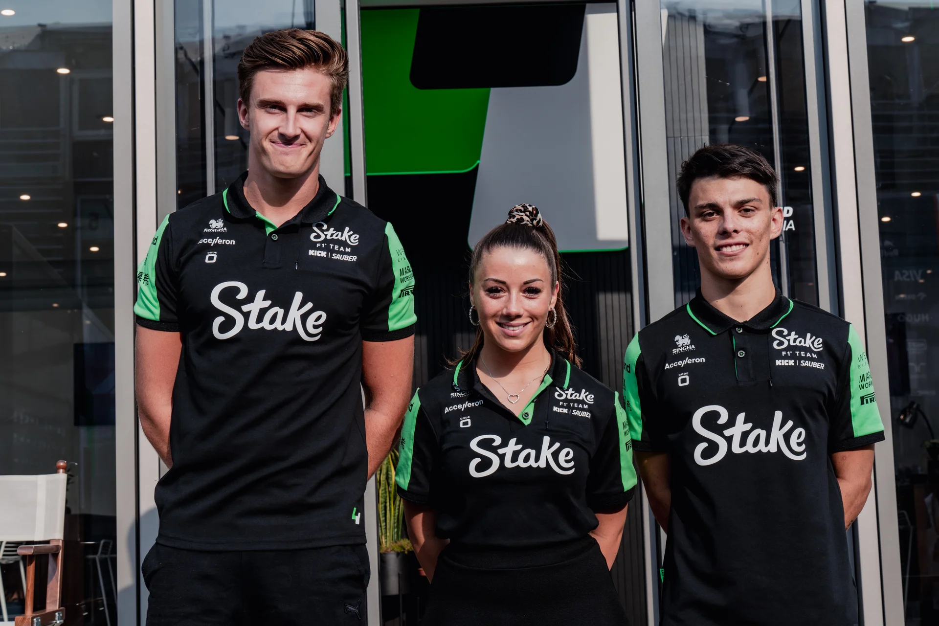 Close-up of Stake F1 Team KICK Sauber Academy drivers at the Italy24 event, wearing team-branded apparel and preparing for the competition.