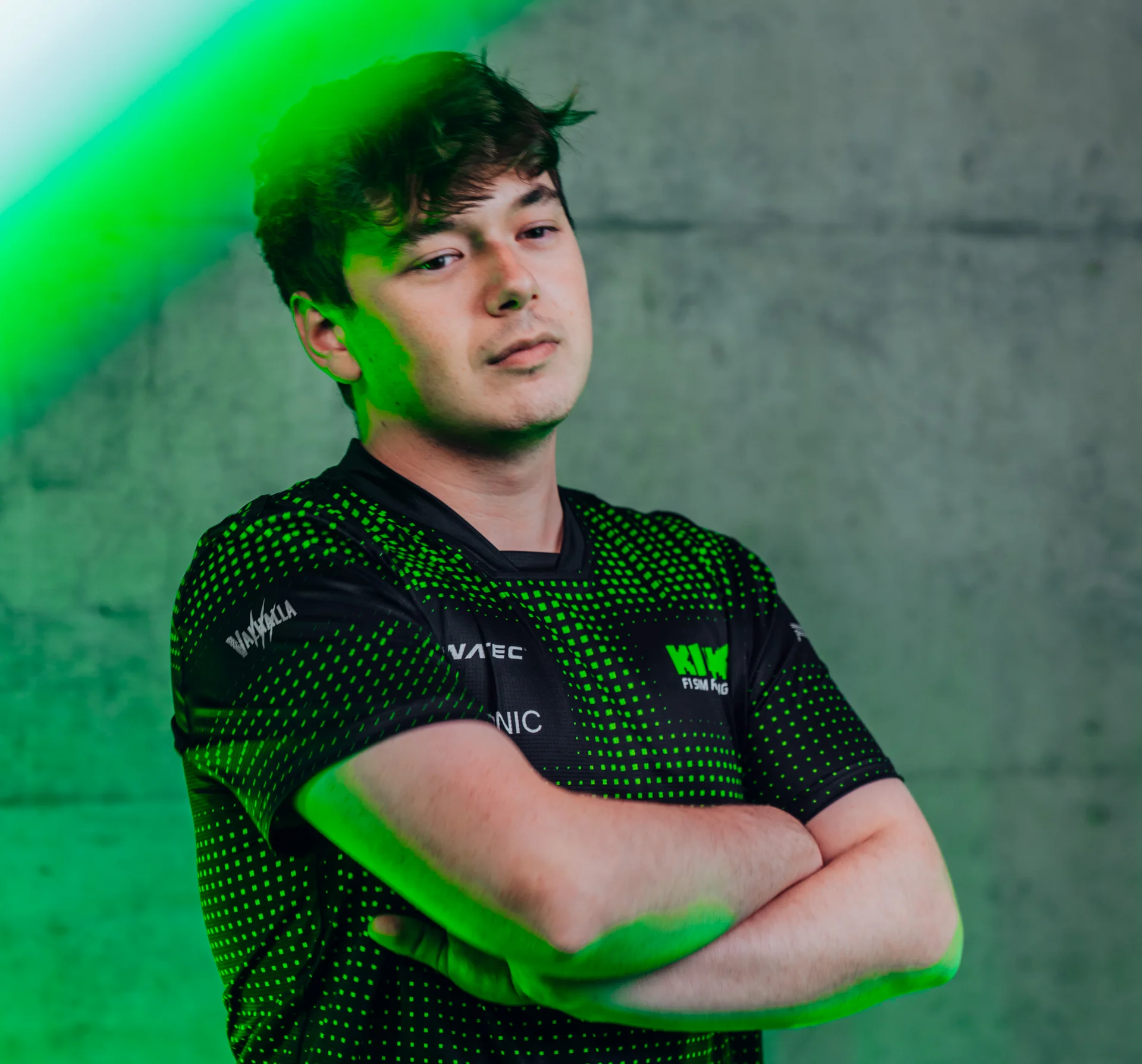 Brendon Leigh, Sauber Motorsport Esports driver, posing for a professional profile photo with a green-lit background.