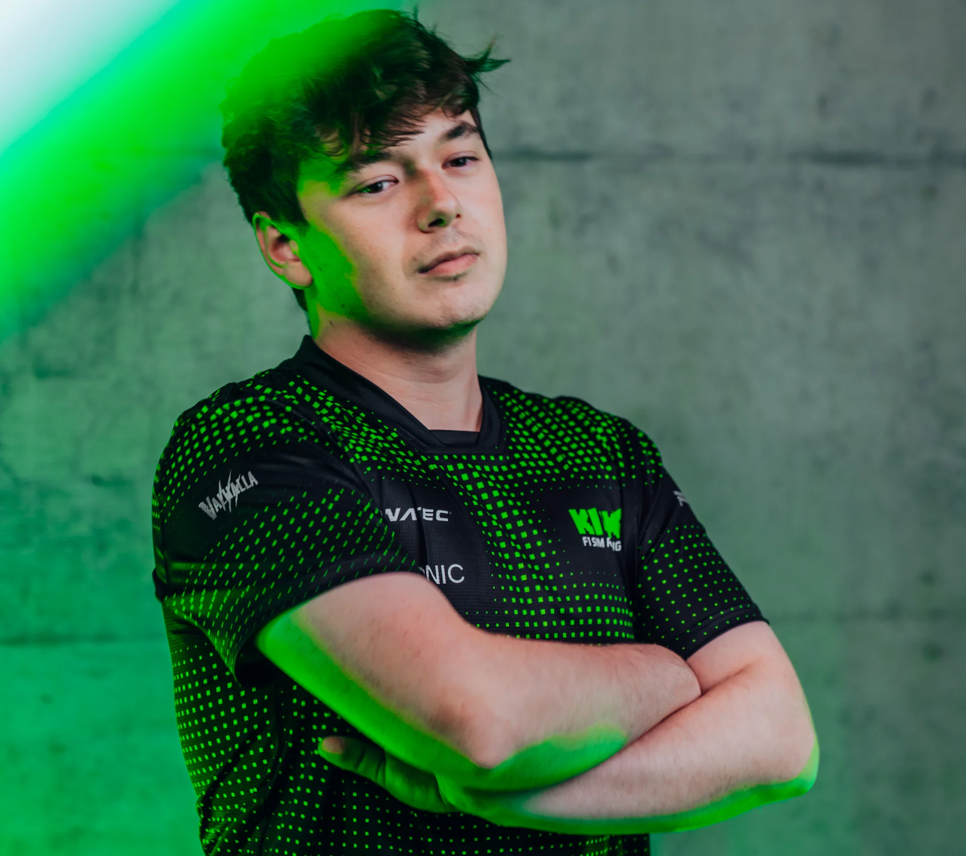 Brendon Leigh, Sauber Motorsport Esports driver, posing for a professional profile photo with a green-lit background.
