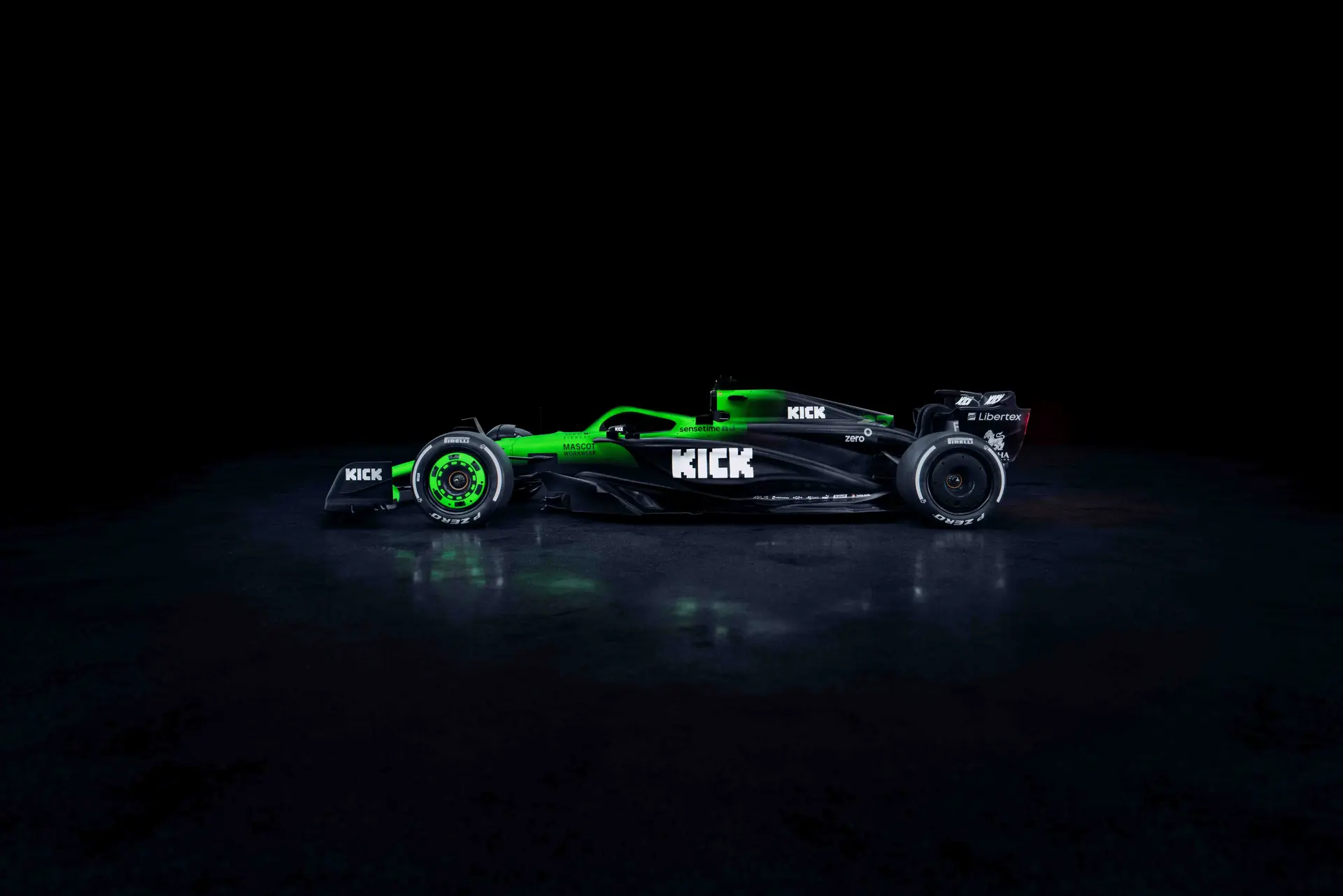 Side view of the Sauber C45 Formula 1 car, illuminated against a dark background, showcasing its aerodynamic shape and sponsor branding.